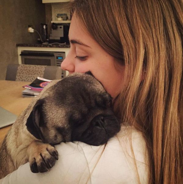 girl hugging pug