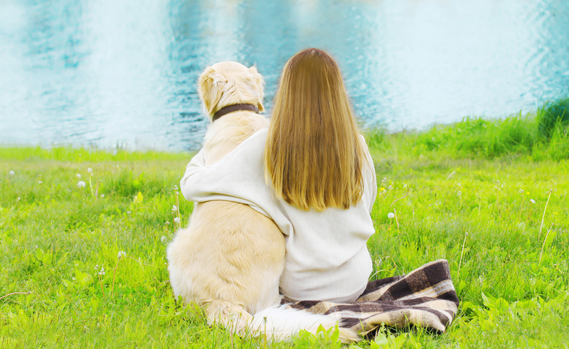 woman with dog by lake